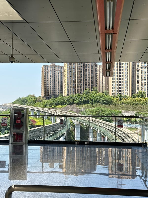 Elderly man uses smartphone at Jiansheng subway station