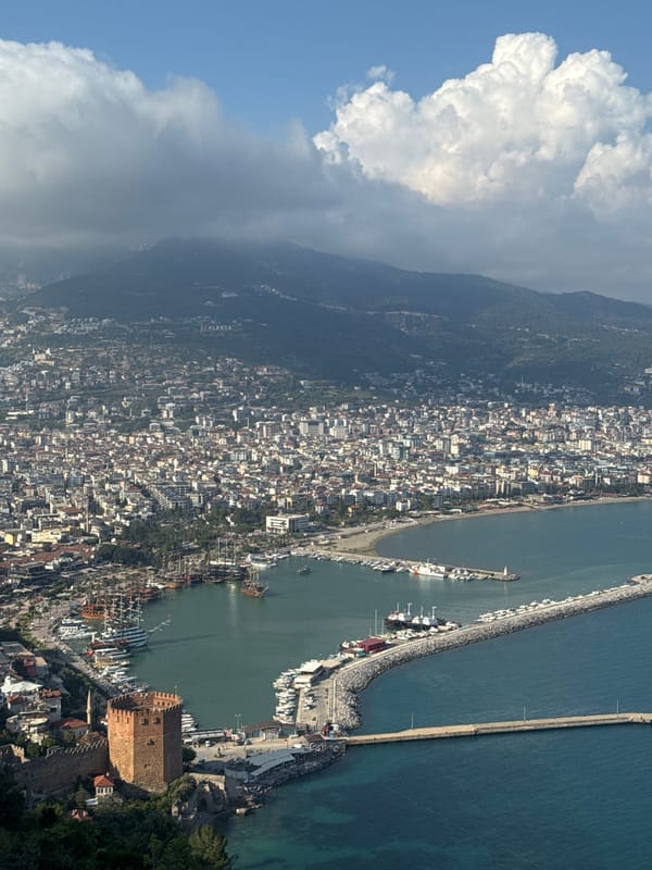 Aerial view captures coastal city between mountains and harbor