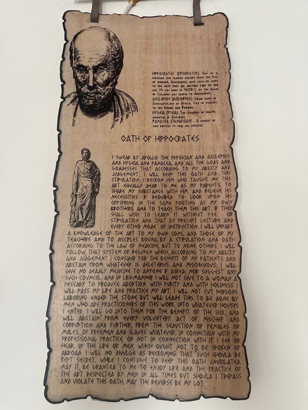 Sofia resident studies handwritten notes near Hippocrates Oath plaque