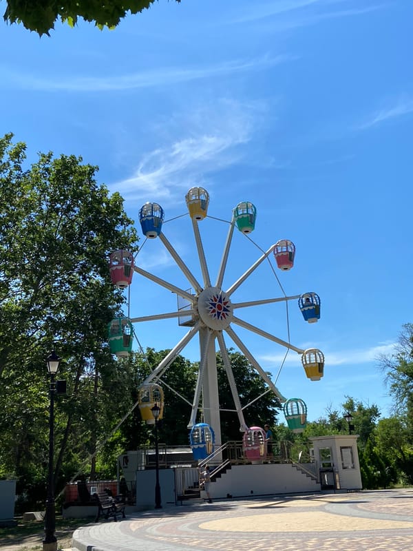 Morning tour of a park with rides, ships, and landmarks