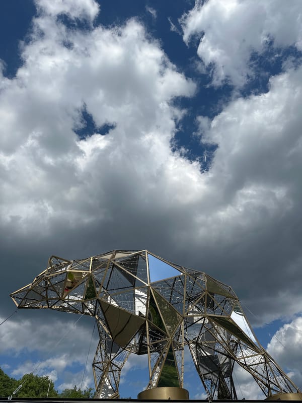 Tourists document geometric sculpture and bridge visits in Wisła