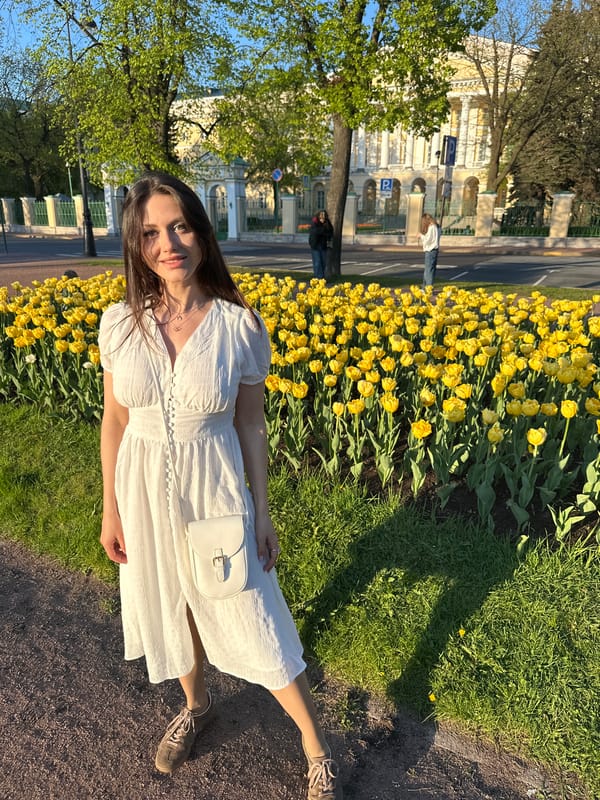 Woman enjoys spring tulips in Saint Petersburg park