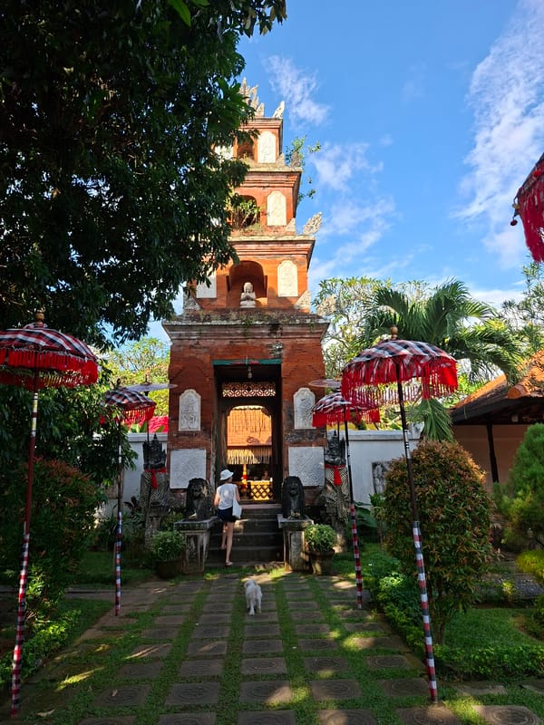 Traditional umbrellas frame historic water palace entrance in Karangasem