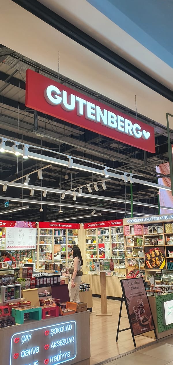 Retail browsing across Baku storefronts, from books to bubble tea