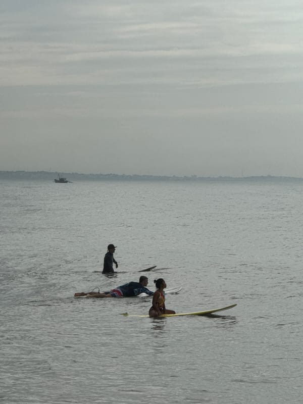 Surfers work choppy swells off the Mũi Né coast