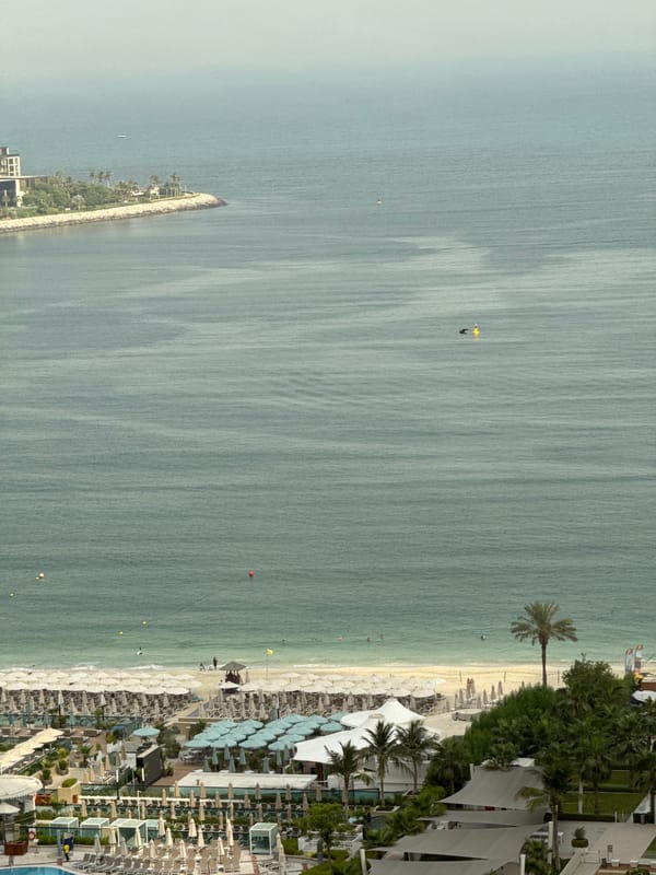 Aerial views of a Dubai resort beach on a busy summer morning