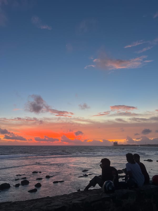 Sunset crowd gathers along Galle Fort's rocky coastline