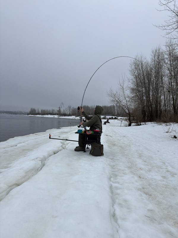 Ice fisherman catches small fish in early morning Chaikovsky session