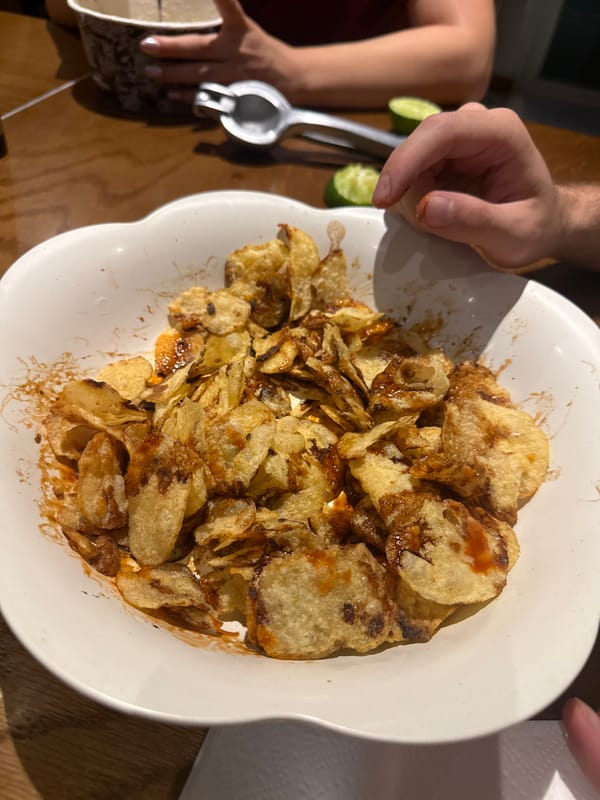 Bowl of potato chips observed during indoor snacking moment
