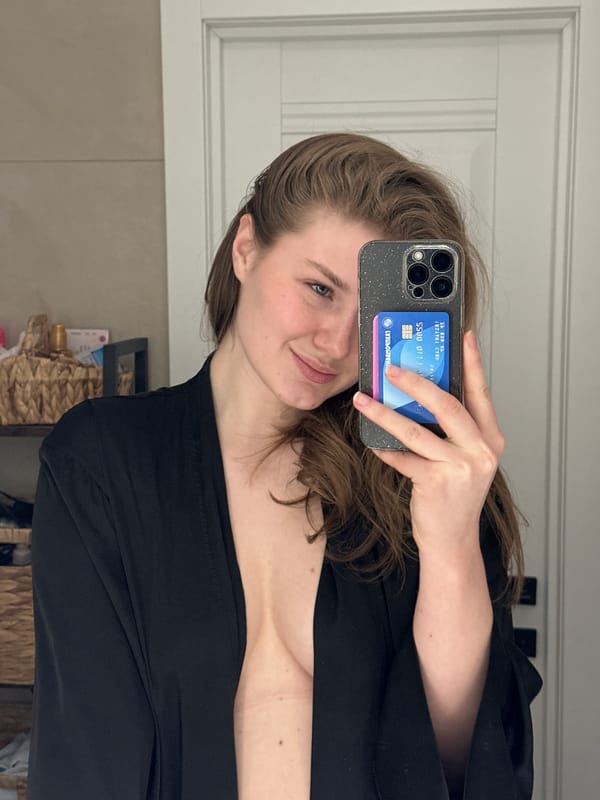 Woman takes mirror selfies with flower in Kazan