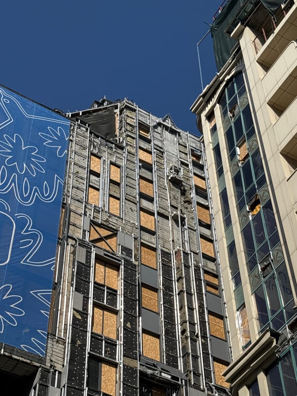 Damaged buildings with boarded windows documented in Kyiv
