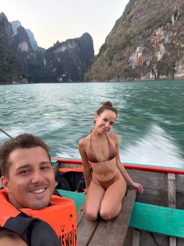 Tourists travel by longtail boat through Khao Phang waters