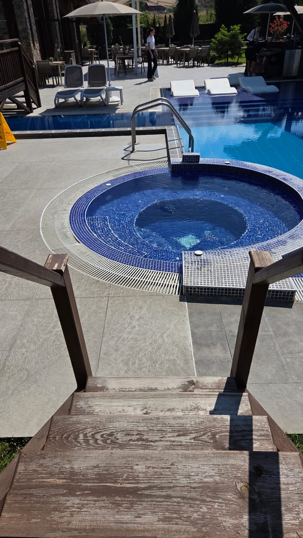 Resort pool and jacuzzi area on a calm sunny morning