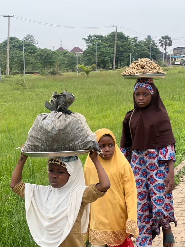 Walking a dirt path through Jos, Nigeria, on a cloudy day