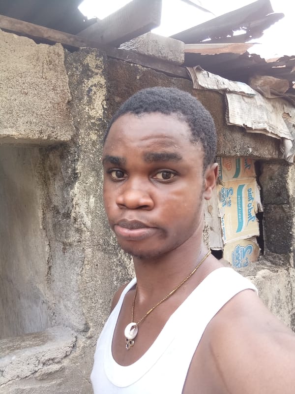 Man in white tank top observed near wall