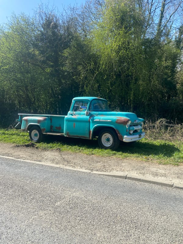 Rusted turquoise pickup truck parked roadside in Nantmawr