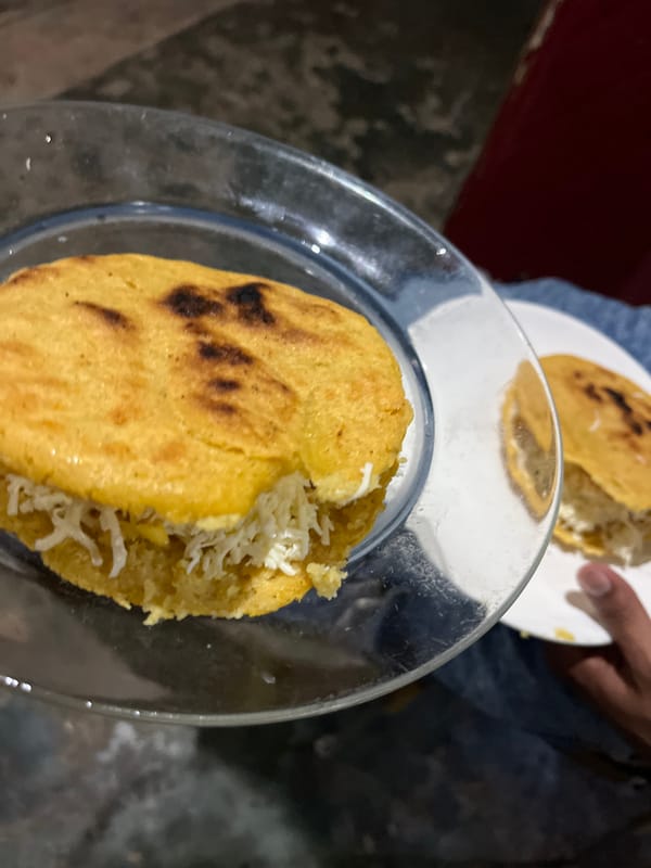 Arepas on the griddle, small dogs at home in Juan Griego