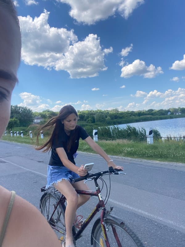 Cycling past an abandoned building on a quiet rural road