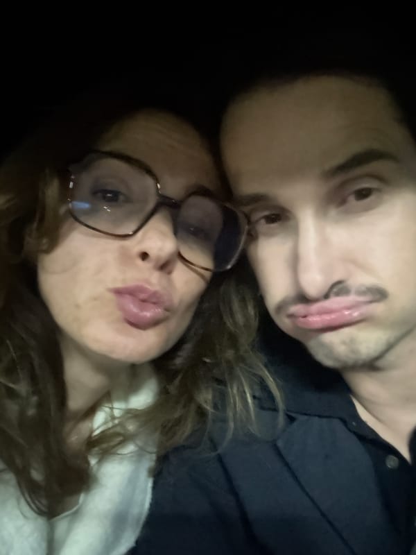 Two people take selfie in dimly lit Loures location