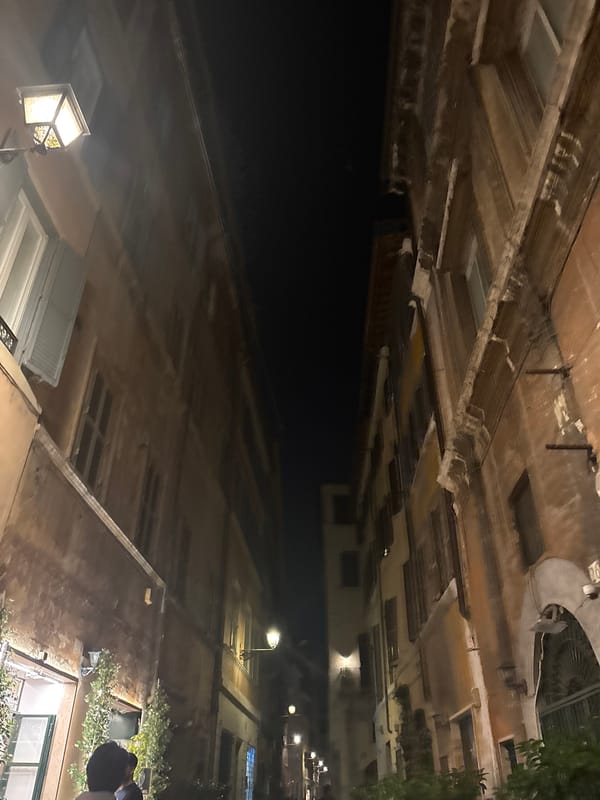 Nighttime upward street photography captures illuminated urban buildings