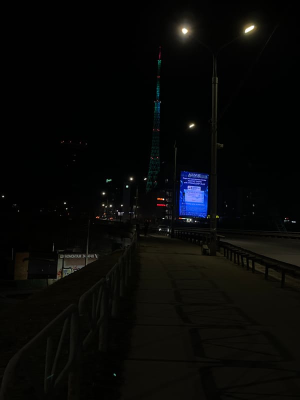 Illuminated advertisement billboard captured in nighttime Perm street scene