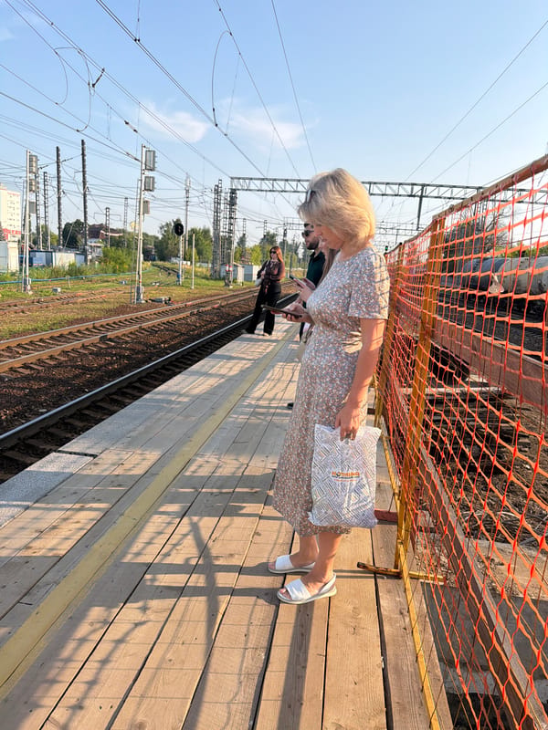 Busy morning at a city train platform and surrounding streets