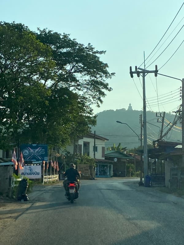 Traffic flows through Chalong streets on sunny morning