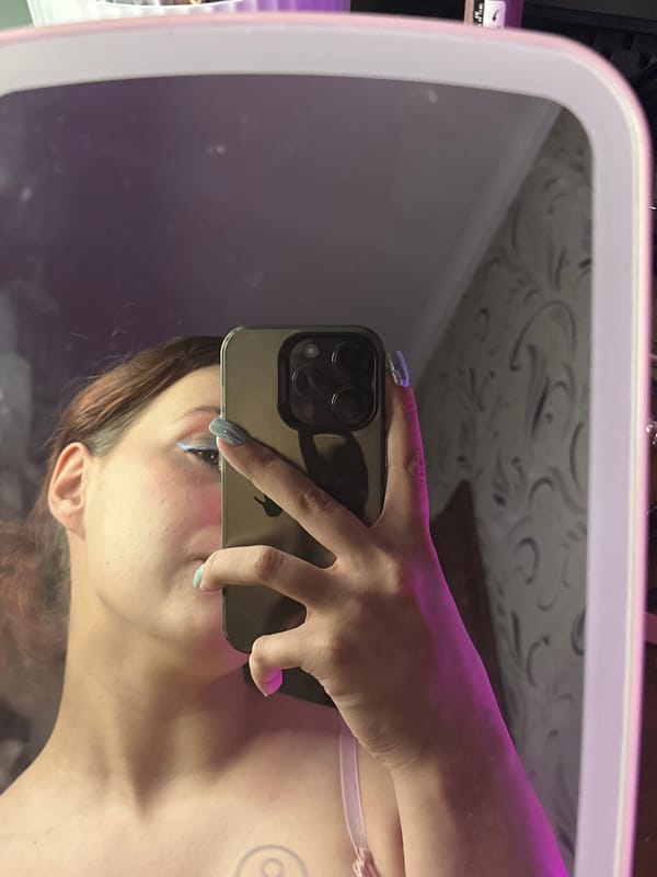 Purple-lit bedroom selfie session in Bishkek