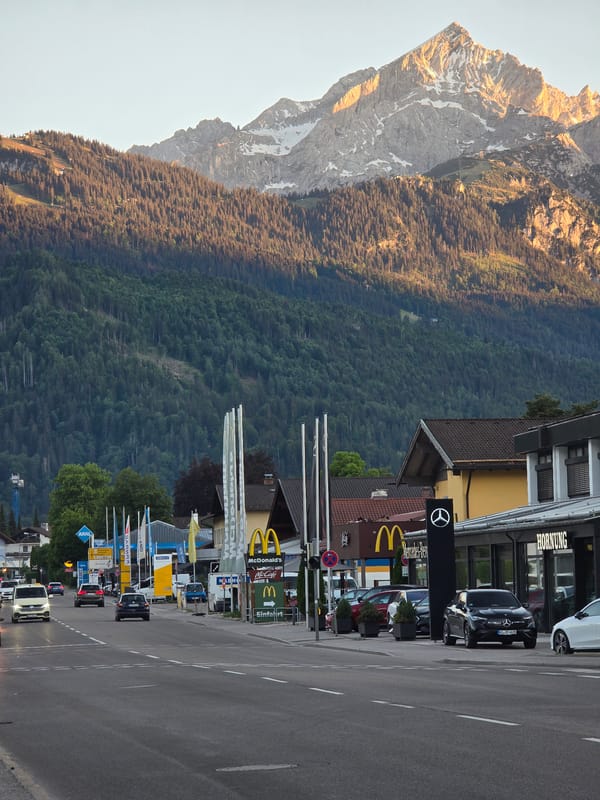 Evening street life documented across Garmisch-Partenkirchen's Alpine backdrop