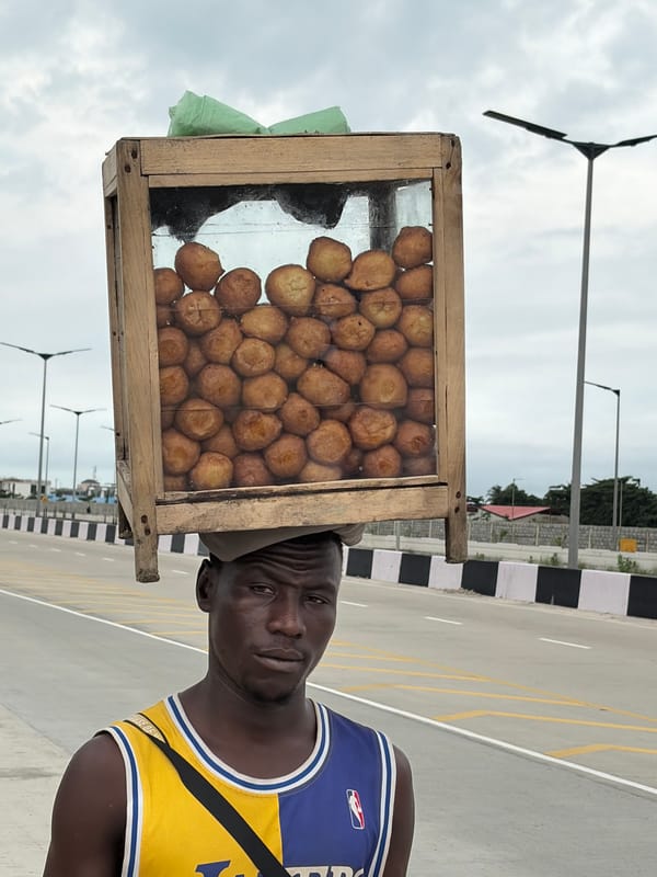Street life and vendors moving through Igboefon, Lagos