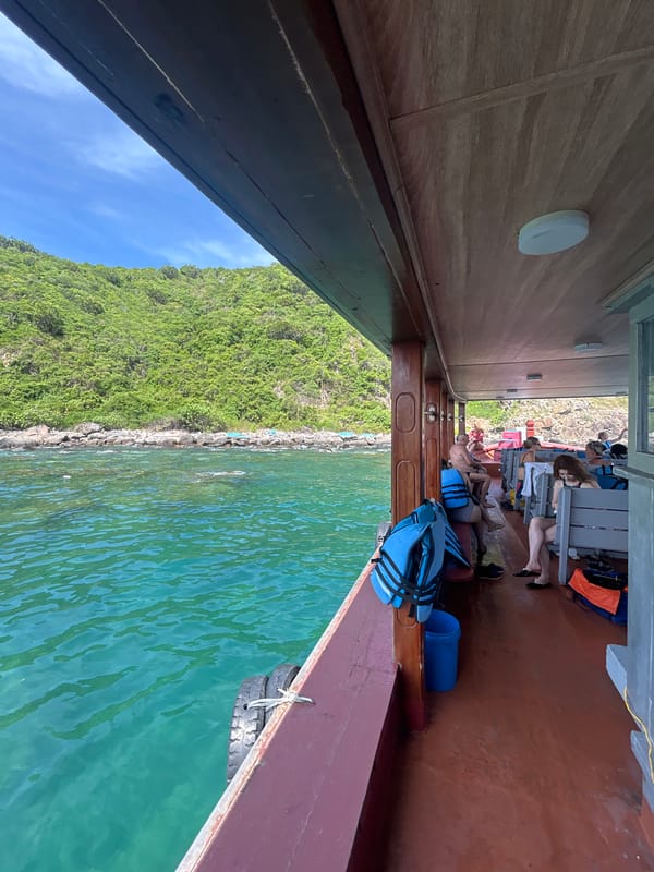 Cruising Nha Trang's rocky turquoise coastline by boat