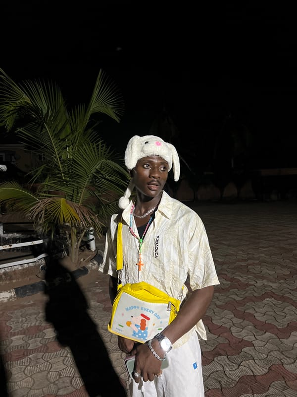 Young person in bunny hat observed outdoors at night