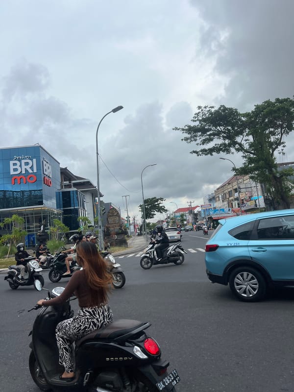 Heavy motorcycle traffic fills Kuta street during morning rush