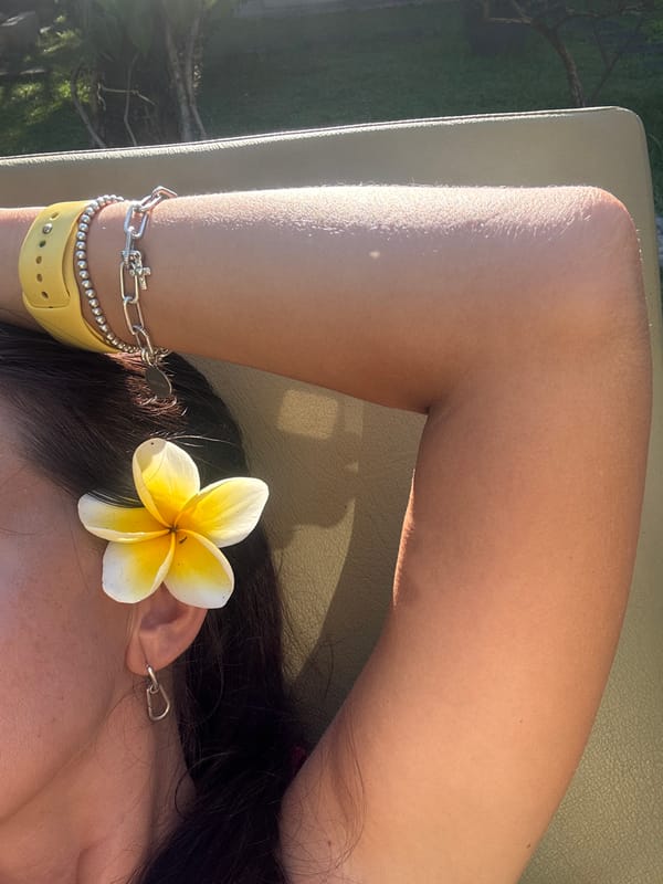 Tourist relaxes poolside with flowers in Kuta Selatan
