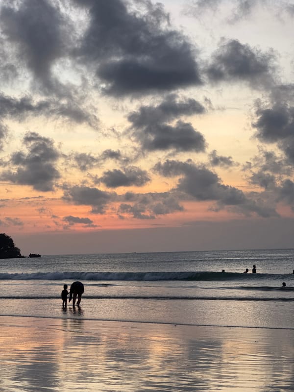 Sunset beach activity in Kuta Selatan, with horses, crowds, and stormy skies
