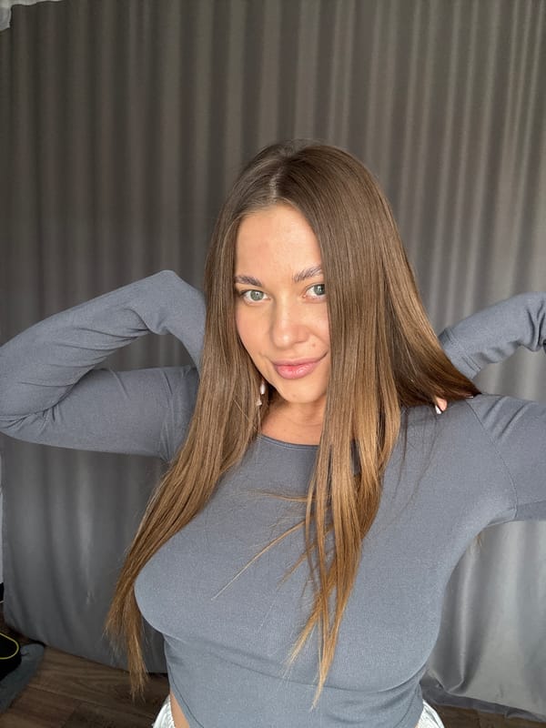 Woman takes morning selfies with cat in Chernushka apartment