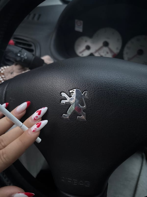 Woman takes smoking break in parked car, Plovdiv