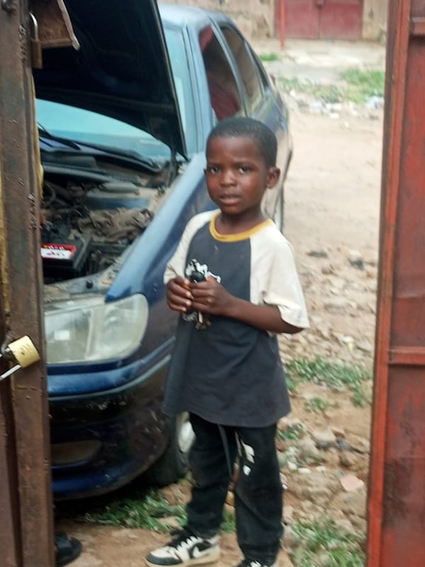 Blue car with hood open in Pantame, Nigeria