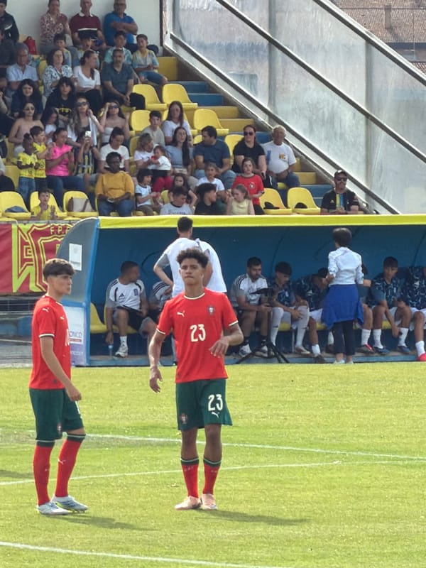 Soccer match underway in Bragança, Portugal on sunny afternoon