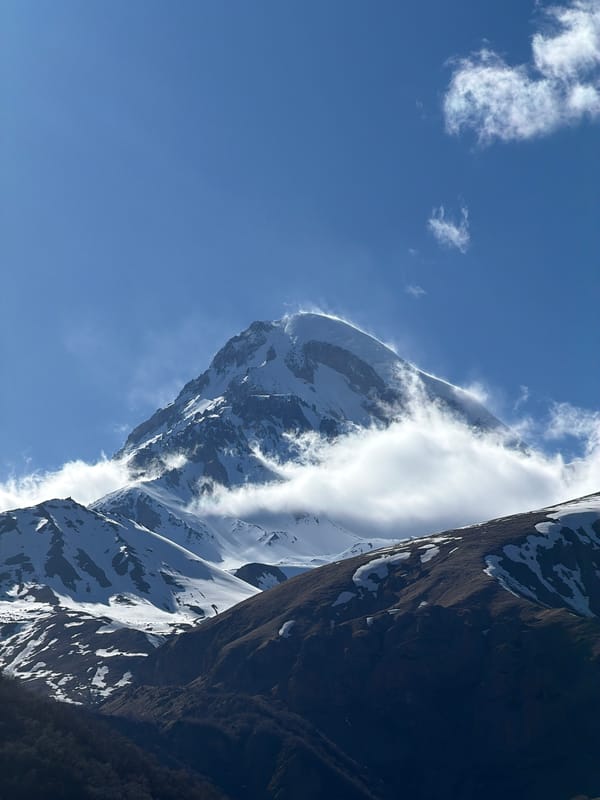 Mountain landscapes and stone cross documented in Gergeti, Georgia