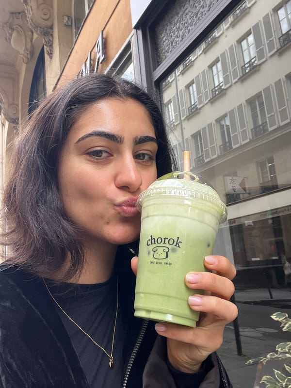 Woman enjoys matcha latte at Korean cafe in Paris