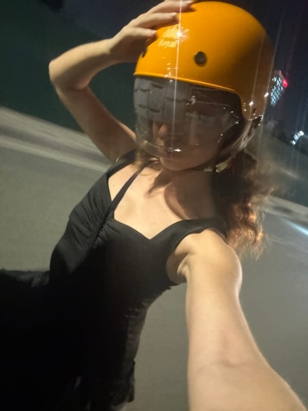 Hanoi night scenes: city lights, a helmet, and a phone screen