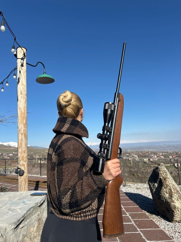 Woman with rifle spotted overlooking landscape in Byurakan, Armenia