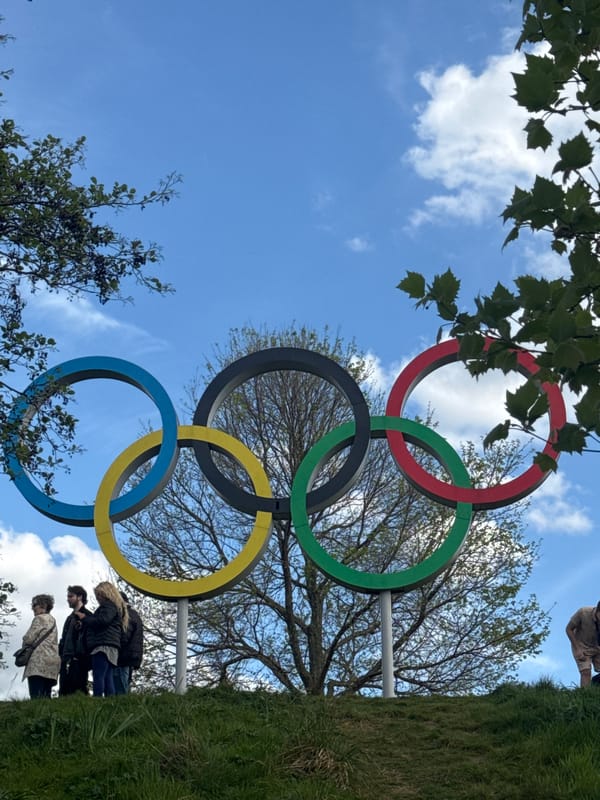 Visitor documents Olympic Park landmarks under afternoon London skies