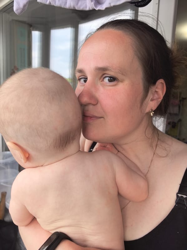 Mother holds baby close in tender moment, Frolы Russia