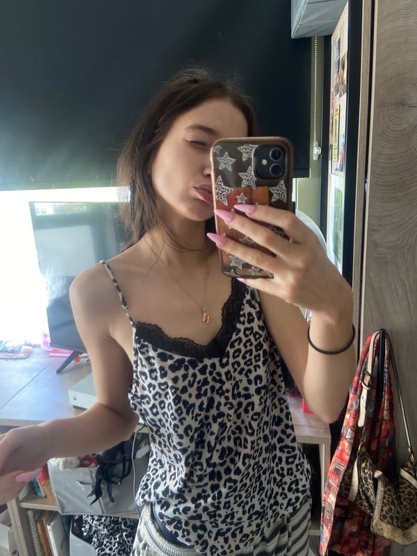 Woman takes bedroom selfie in leopard print top, London