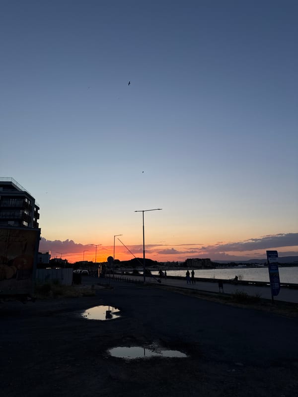 Nesebar promenade at golden hour with tourist trains rolling by