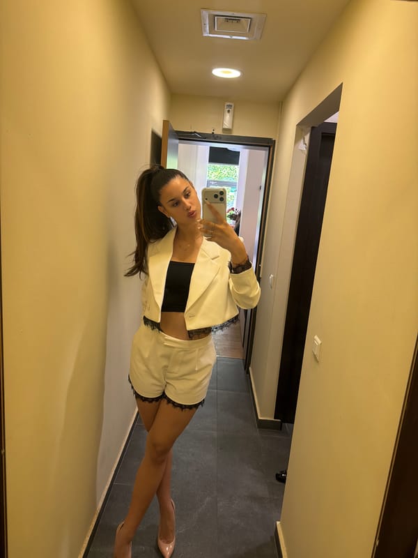 Woman in white blazer photographed at two Sofia locations