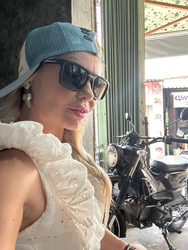 Woman observed near closed storefront with motorcycle in Nha Trang