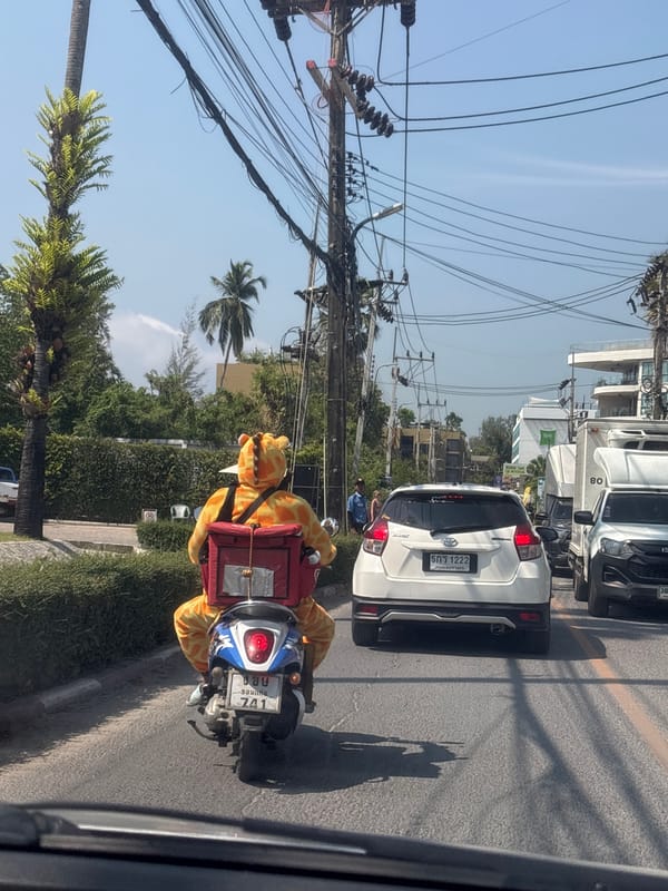 Giraffe-costumed delivery rider spotted on motorcycle in Thailand